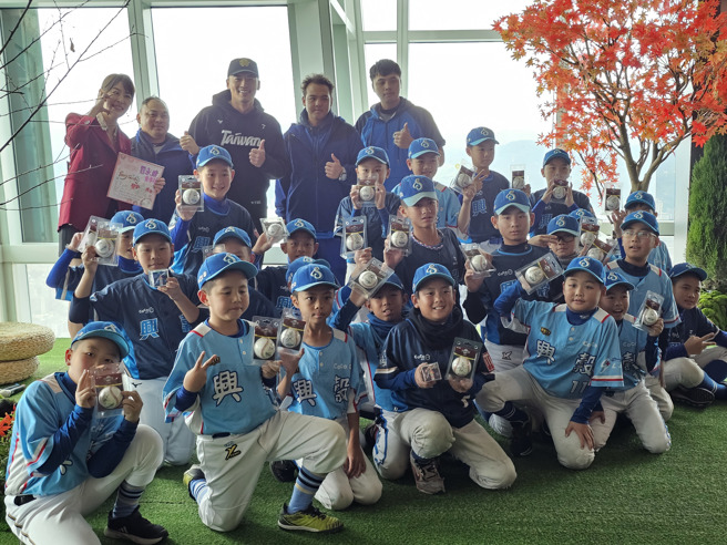 朱育贤（后排中）出席台北101活动，和兴谷国小少棒队球员亲切互动。（陈筱琳摄）