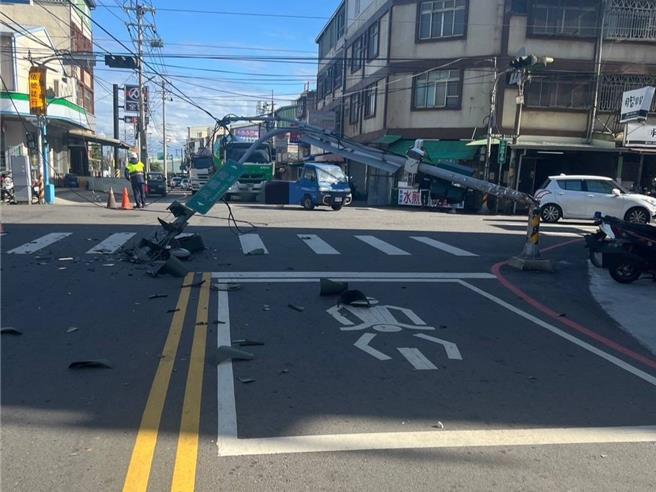 台中市大肚区游园路与中蔗路口交通号志26日13时多遭车辆勾扯倒地，停等红绿灯的骑士险些遭砸中，连忙后退好几步，相当惊险。（民眾提供／潘虹恩台中传真）