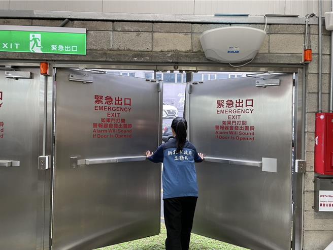 新北市工务局完成稽查辖内大型商场、百货公司共计64间场所设备安全，检查人员正在稽查紧急出口是否可以正常闭合。（新北市工务局提供）
