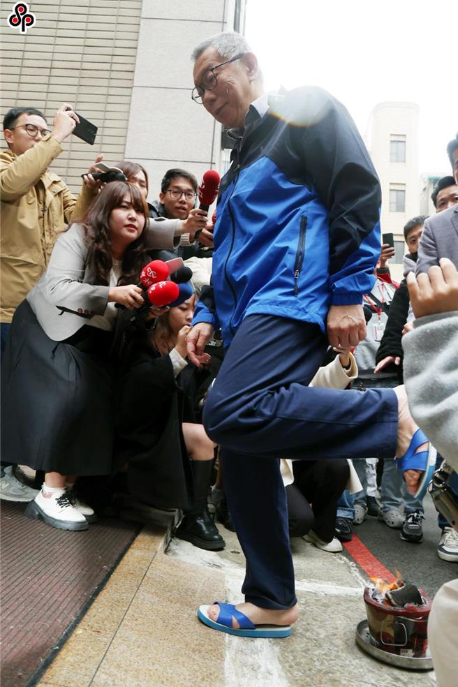台北地检署侦办前台北市长柯文哲（中，蓝衣者）涉及京华城容积率与政治献金假帐案，在押的前台北市长柯文哲移审法院后，北院27日裁定交保，完成交保后，穿着蓝白拖离开返家，进入家里前跨火炉去霉运。（中时资料照片，邓博仁摄）