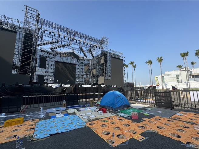 民眾出動野餐墊、紙箱等物卡位，還有人現場搭帳棚輪班等候。（洪靖宜攝）