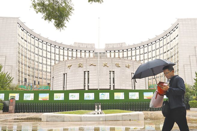 中国人民银行近日发布《中国金融稳定报告》，表示部分农村中小金融机构存在一定风险。图为民眾经过位于北京的中国人民银行。（中新社）