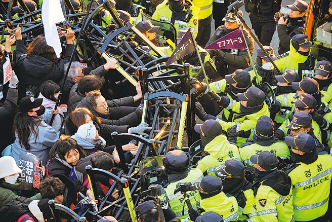 韩国公调处人员周五与总统警卫处经过5个多小时对峙，仍无法逮捕被弹劾的总统尹锡悦。图为反尹的抗议民眾，在总统官邸附近与警察发生衝突。（路透）