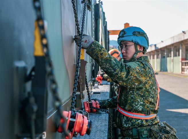 官兵以链条式繫固器将雷达车厢进行固定，确保机动安全。
（记者谢承宏摄）