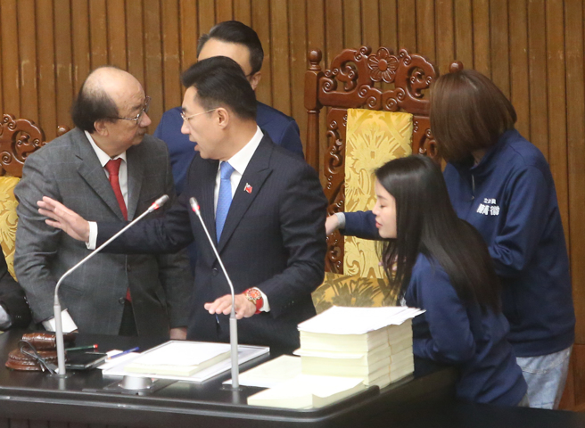 立法院院会20日审查114年度中央政府总预算案，民进党立院党团总召柯建铭（前左）到主席台和立法院副院长江启臣（前中）交换意见时，被国民党立委上前阻止，一度动怒。（赵双杰摄）