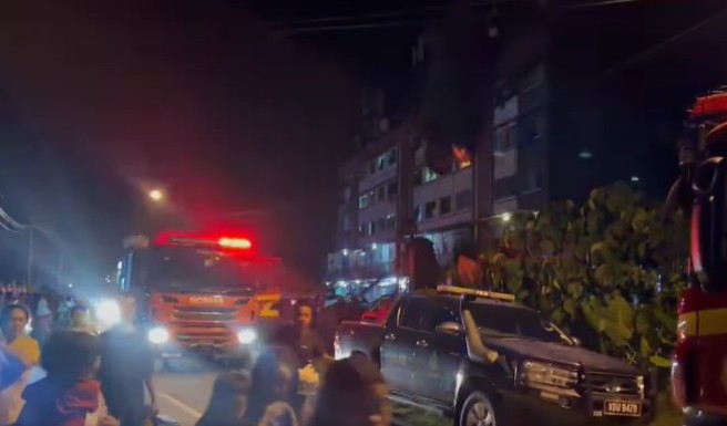 马来西亚一处公寓火警，消防队员在射水灌救突中，意外触电倒地被送医。（翻摄脸书INFO X）