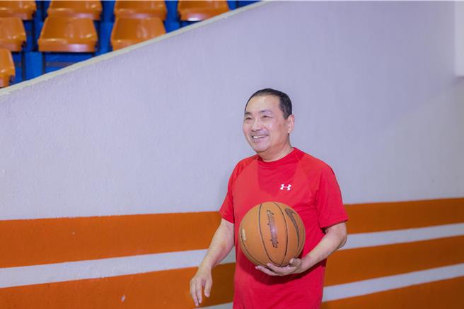 新北市長侯友宜換上運動裝、拿著籃球走入球場，為市府拍攝賀歲短片。（新北市府提供）