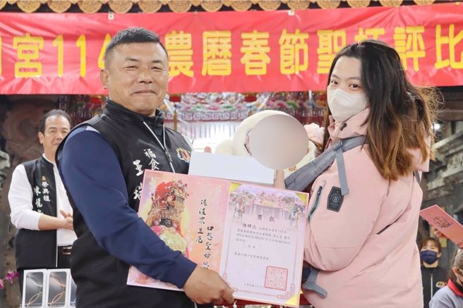 颁奖典礼上，幸运得主也抱着婴孩上台领奖，萌翻全场。（吕妍庭摄）