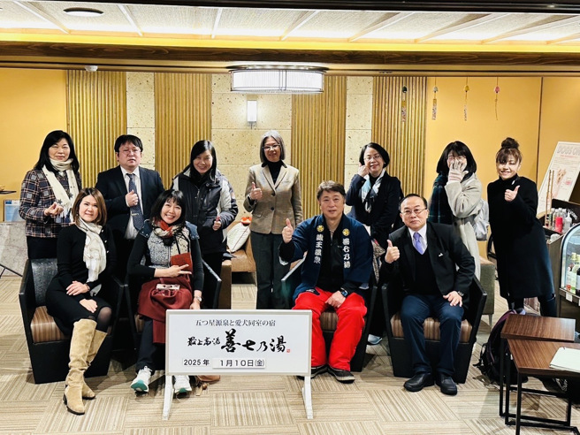 日本山形县「最上高汤 善七乃汤」饭店社长冈崎善七先生(右二)、45公斤的店长狗「ホタル（萤火虫)」、真大国贸系主任林冠汝(第二排左一)。（照片/真理大学提供）