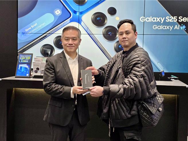 台湾三星电子行动通讯事业部总经理陈启蒙（左）与三星微风南山旗舰馆早鸟预购取机排队首位的消费者合照。（古明弘摄）