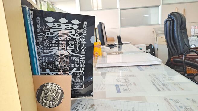 台南市普济殿灯会推出的文创商品，其中黑令旗文书夹、杯垫被认为是警消、医疗职场挡灾法器，放在值班台很有用。（程炳璋摄）