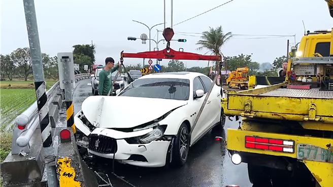 疑因天雨路滑，玛莎拉蒂轿车失控路旁护栏及路牌，车头严重损毁。（民眾提供／萧嘉蕙台东传真）