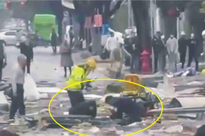 网友拍下苏奕帆（右）对躺在马路上的伤者进行CPR，郭芸亘（左）在为伤者打点滴画面。（民眾提供／李京升彰化传真）