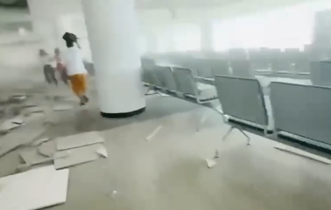 緬甸最大機場曼德勒國際機場遇7.7強震後，大片天花板掉落，旅客以包包護頭驚慌逃離。（圖／Threads網友@156_cwl授權提供）