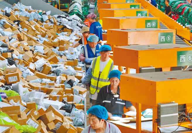 大陆推出上海国际金融中心建设行动方案，鼓励跨境金融探索。图为大陆电商618促销活动下，中国邮政物流中心忙碌作业。（新华社）