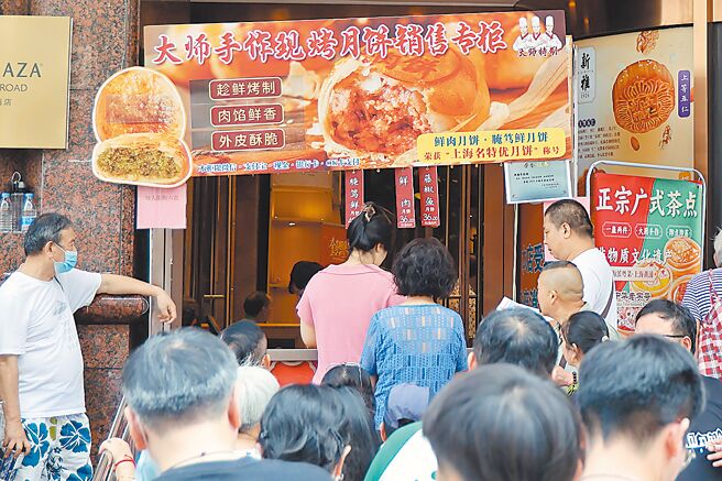 中秋佳节将近，今年大陆市场无论线上线下，都没出现往年1000元人民币起跳的豪华天价月饼。示意图为上海市民1日排队买月饼（中新社）
