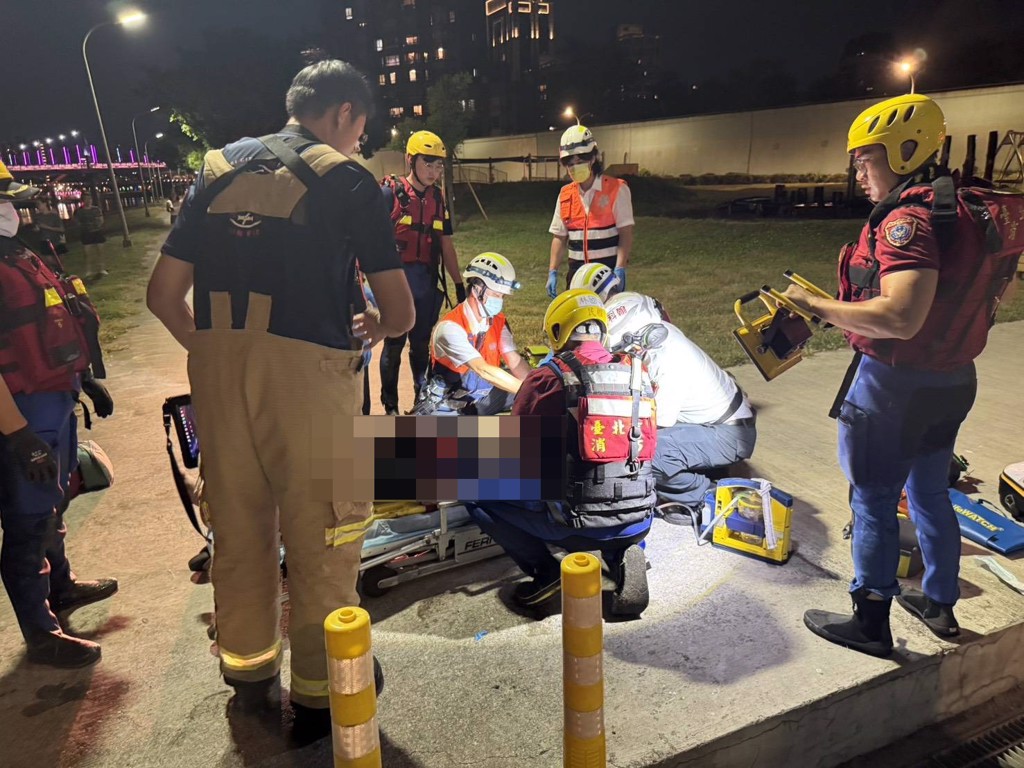 內湖區成美橋下晚間8時許,有民眾報案疑似有人墜落基隆河,消防隊獲報到場進行搜救。(翻攝畫面)