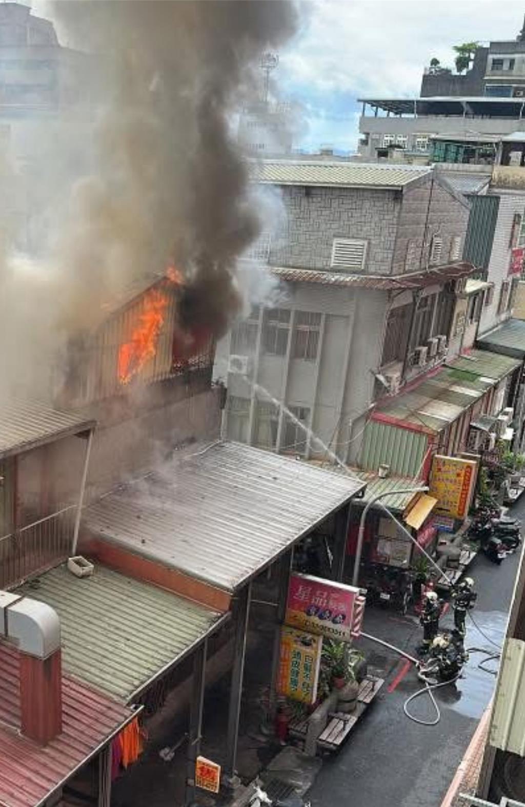 宜蘭縣羅東鎮民生市場旁的長春路今（19日）下午4時許，三層樓建物頂樓鐵皮加蓋突起熊熊火焰，濃煙滾滾直竄天空。（民眾提供／吳佩蓉宜蘭傳真）