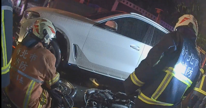 新北市板桥区大观路一段，发生汽机车车祸，骑士右脚受困轮胎下，所幸救出送医时意识清楚。（民眾提供）