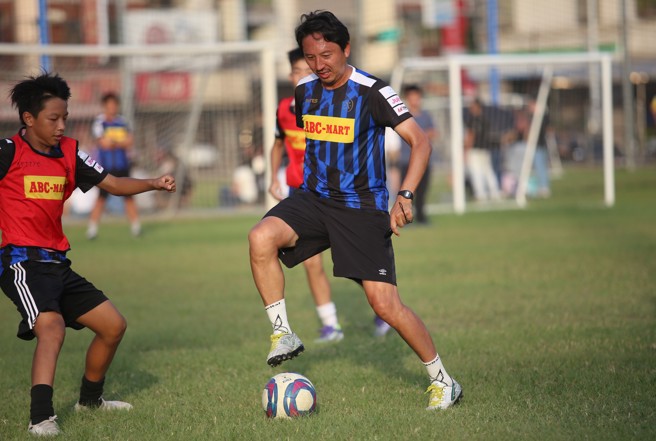橋本英郎（中）和教練團親自下場，跟台灣小朋友踢對抗賽。（李弘斌攝）