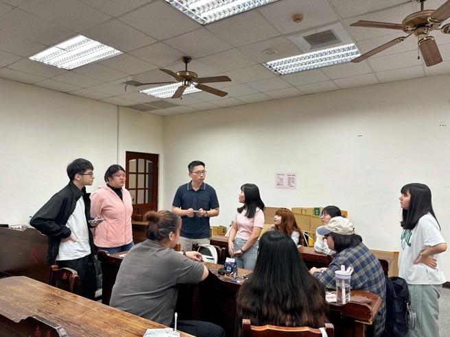 南華大學文創系以辦桌文化展現創意實踐，畢業展將於12月12日登場，學生進行籌備討論。（南華大學提供）