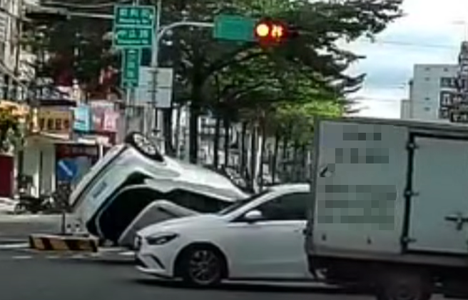 有民眾拍下一輛休旅車一切西瓜撞上，導致撞上行人庇護島翻車。（圖／翻攝自臉書爆料公社）